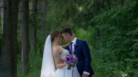 Bride and groom look at each other and kisses Stock Footage 81399495