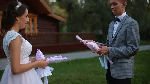 The bride and groom play with soft toys Stock Footage 83465074