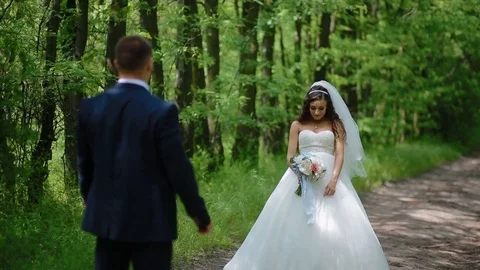 Bride and groom pose in the wood Stock Footage