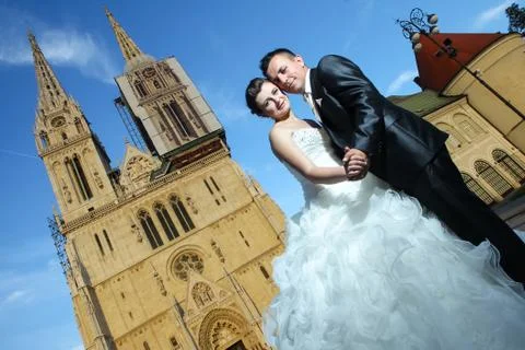 Bride and groom posing in front of Cathedral Stock Photos