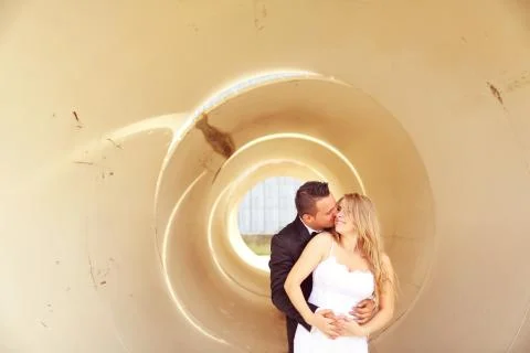 Bride and groom posing in a pipe Stock Photos