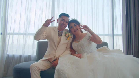 Bride and Groom Posing Playfully with Peace Sign on Wedding Day Stock Footage 333375208