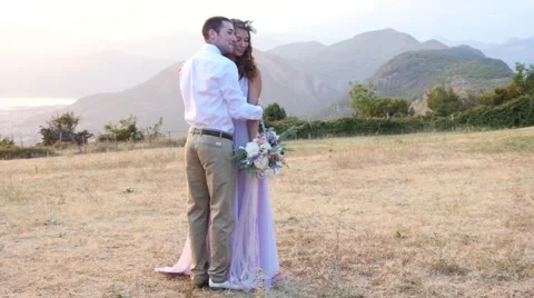 The bride and groom posing on the sunset Stock Footage 58146815