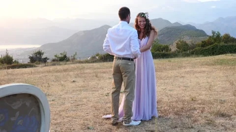 The bride and groom posing on the sunset Stock Footage 58147186