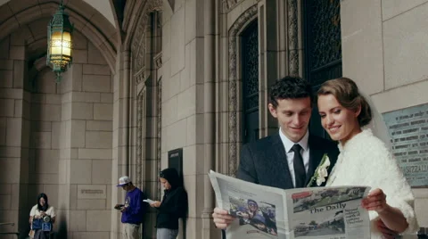 Bride and groom reading the newspaper Video stock 48148331