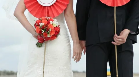 The Bride And Groom Rear View Holding In Their Hands Red Flowers Stock Footage 52016353