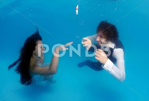 Bride and groom, ring, underwater wedding in pool Stock Photos