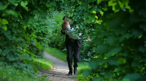 Bride and groom running down the avenue Stock Footage 10896992