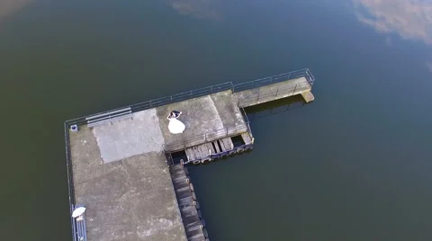 The bride and groom running through the marina, shooting with air quadrocopters Stock Footage 65497944