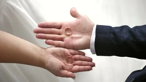The bride and groom show their wedding rings on the palms of their hands Stock Footage 281695344