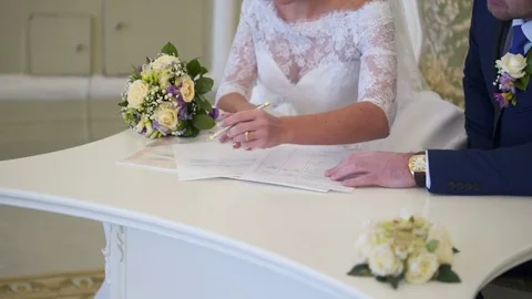 Bride and groom signing documents Stock Footage 73729110