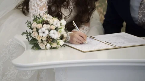 Bride and groom signing documents Stock Footage 82664347