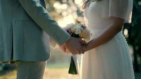 The bride and groom stand opposite each other in an open area on their wedding Video stock 224862553