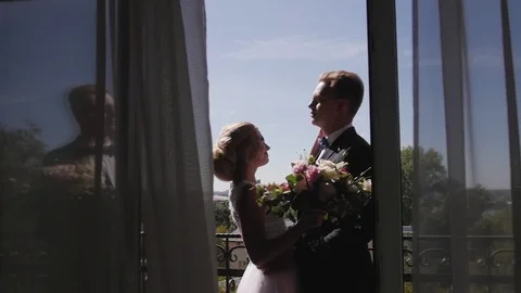 The bride and groom standing on the balcony waiting for the wedding Video stock 81940940