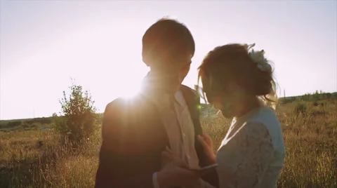 Bride and Groom at Sunset Using Smartphone Stock Footage 63074111