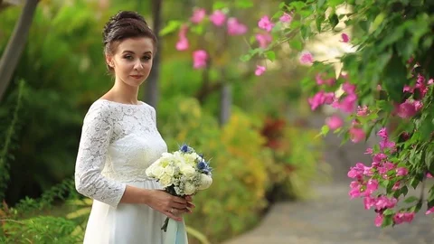 The bride and groom surrounded by palm trees looking into the distance Stock Footage 76180206