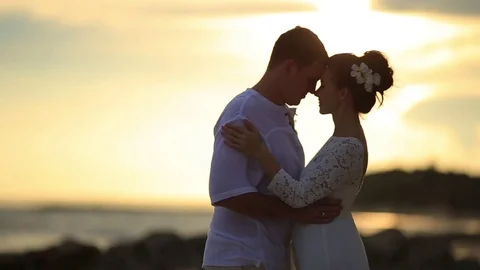 The bride and groom surrounded by palm trees looking into the distance Stock Footage 76180616