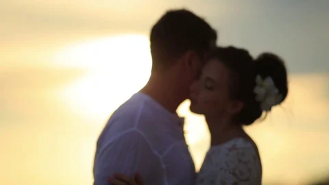 The bride and groom surrounded by palm trees looking into the distance Stock Footage 76180630