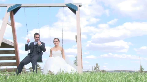 Bride and Groom on Swing Set Stock Footage 42399120