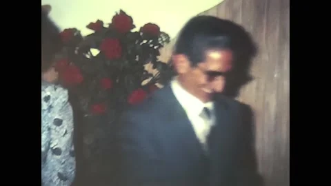 Bride and groom take group photos and kiss guests in the 70s Stock Footage 229763365