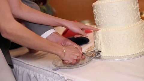 Bride and Groom Take Slice of Wedding Cake Stock Footage 116399072