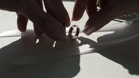 The bride and groom take wedding rings lying near the bouquet, close-up Stock Footage 317606672