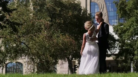 The bride and groom walk around the city, dancing on the background of a Video stock 81497302