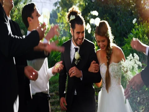 Bride and groom walking down while guests toss petals 4K 4k Stock-Footage 83141455