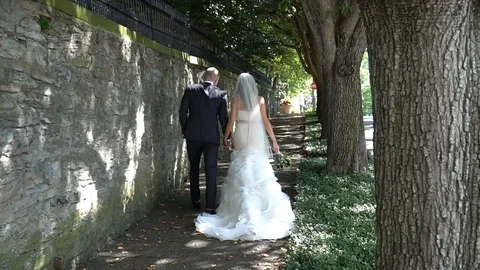 Bride and Groom Walking Down Sidewalk Stock Footage 87093681
