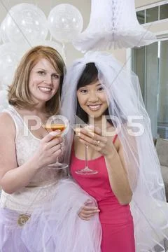 Bride And Her Friend Holding Juice Glasses Stock Photos