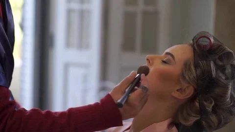 Bride Applying Wedding Makeup by Professional Make-up Artist Stock Footage 74969509