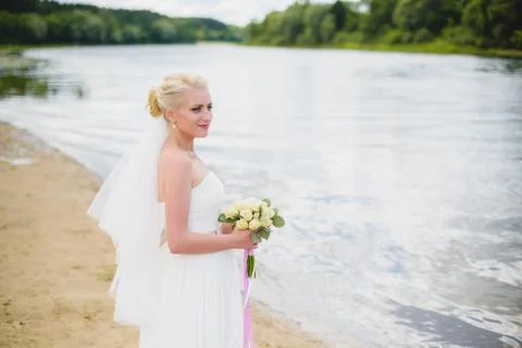 Bride on a background of the river Stock Photos