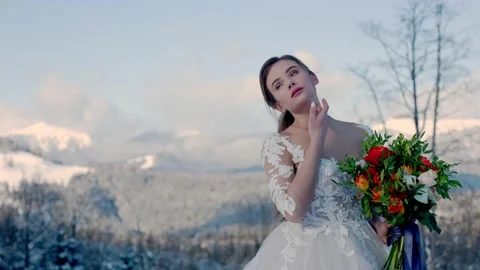 Bride on the background of snow-capped mountains Stock Footage 149289202