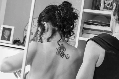 A bride from behind, reflected in a mirror, is wearing a wedding dress Stock Photos