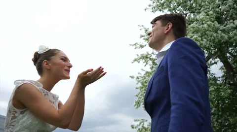 Bride blows up confetti to the groom Stock Footage 61783351