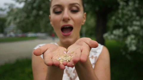 Bride blows up confetti from her hands Stock Footage 61783342