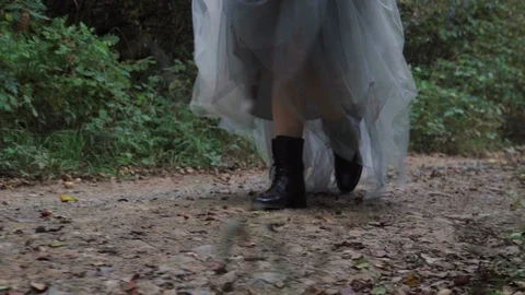 Bride with boots walking in the forest Stock Footage 116264451