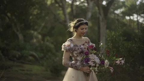 The bride with a bouquet in her hands in the forest Stock Footage 87145560