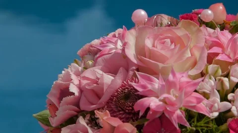 Bride bouquet is lying on sun deck blue swimming pool Stock Footage 75830481