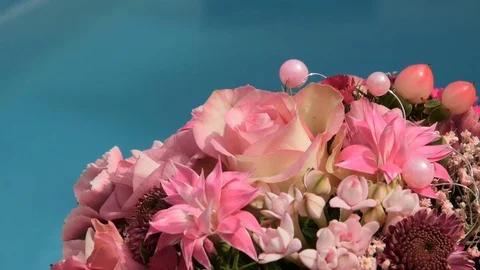 Bride bouquet is lying on sun deck blue swimming pool Stock Footage 75830997