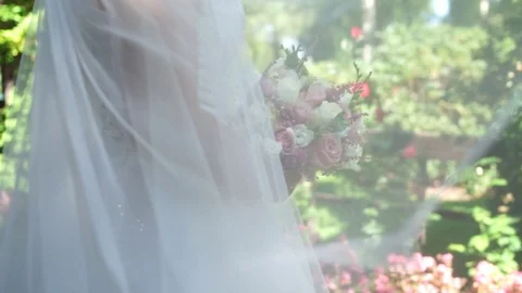 Bride with a bouquet in the park Stock Footage 125333248