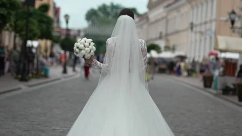 Bride with a bouquet walks in the old town Stock Footage 201252146