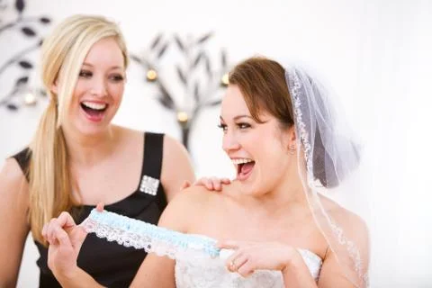 Bride: Bride Plays With Blue Garter Stock Photos