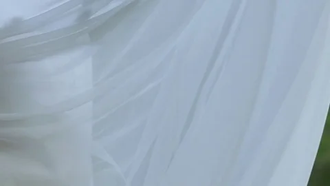 Bride circling and waving dress near waterfall Stock Footage