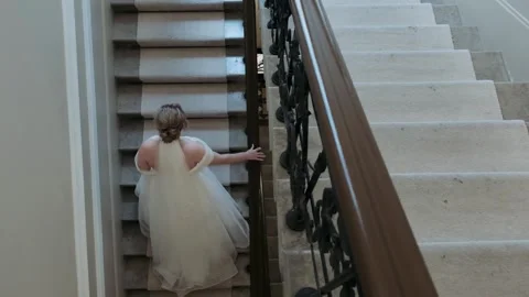 Bride climbs the stairs, view from the back Stock Footage 318163060