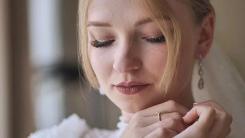 The bride corrects her earring. Stock Photos