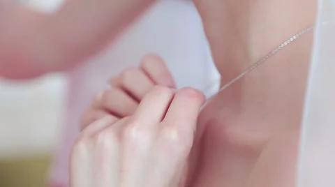 Bride corrects a necklace around her neck Stock Footage 61335705