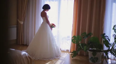 The bride costs near a window.mp4 Stock Footage 56049694