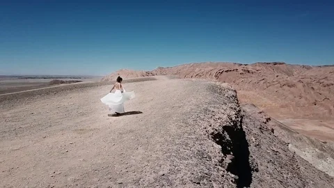 Bride dancing in desert valley Stock Footage 84317964