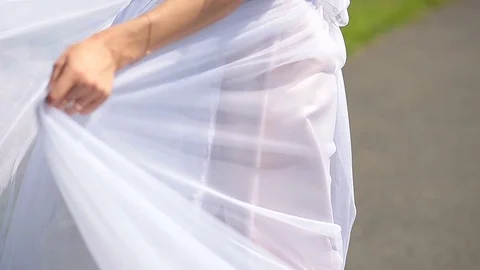 The bride dancing the park on her wedding day in a white dress with a train Video stock 82585355